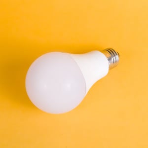 Light bulb on yellow background